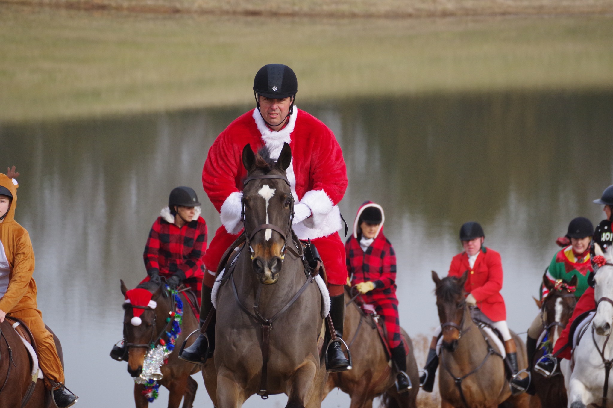 riders on horseback dressed in fun holiday colors and costumes