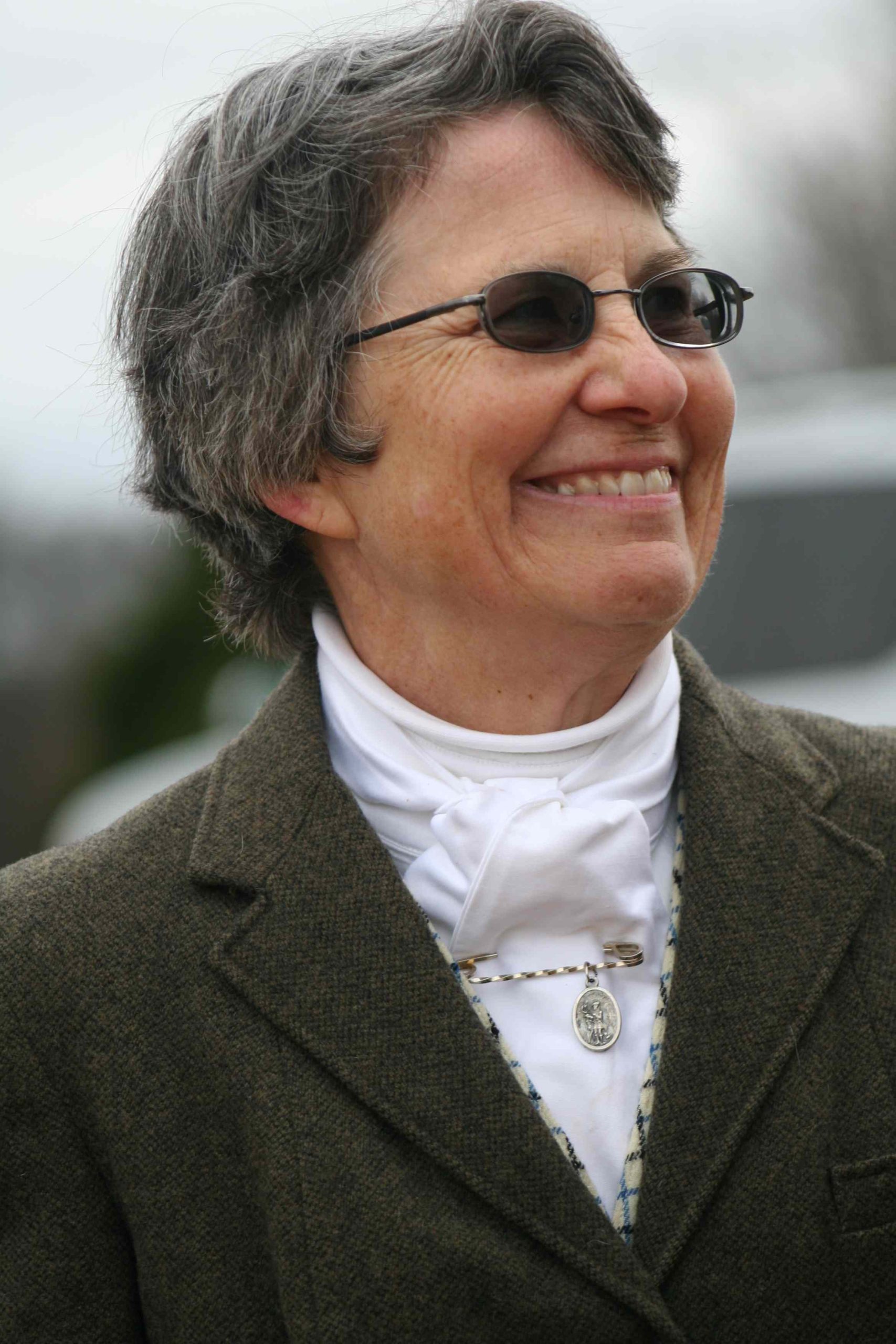 smiling woman with hunt coat and short hair