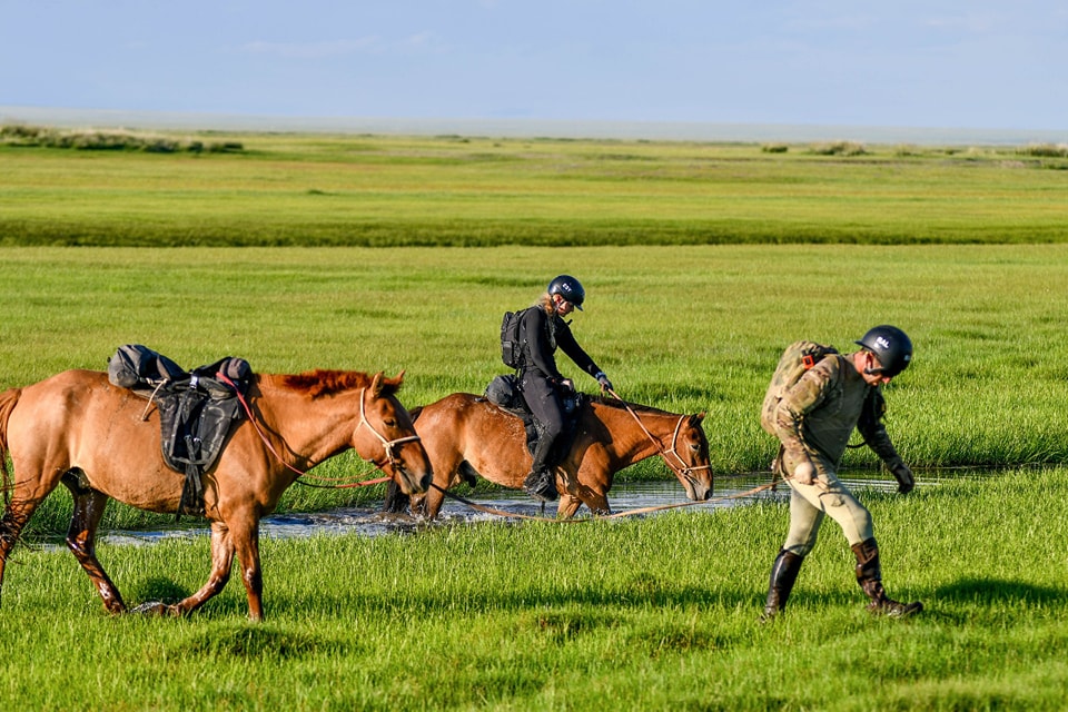 Reid Albano in the 2023 Mongol Derby after walking through a river. Photo Credit Bayarsaihan Ochiroo.
